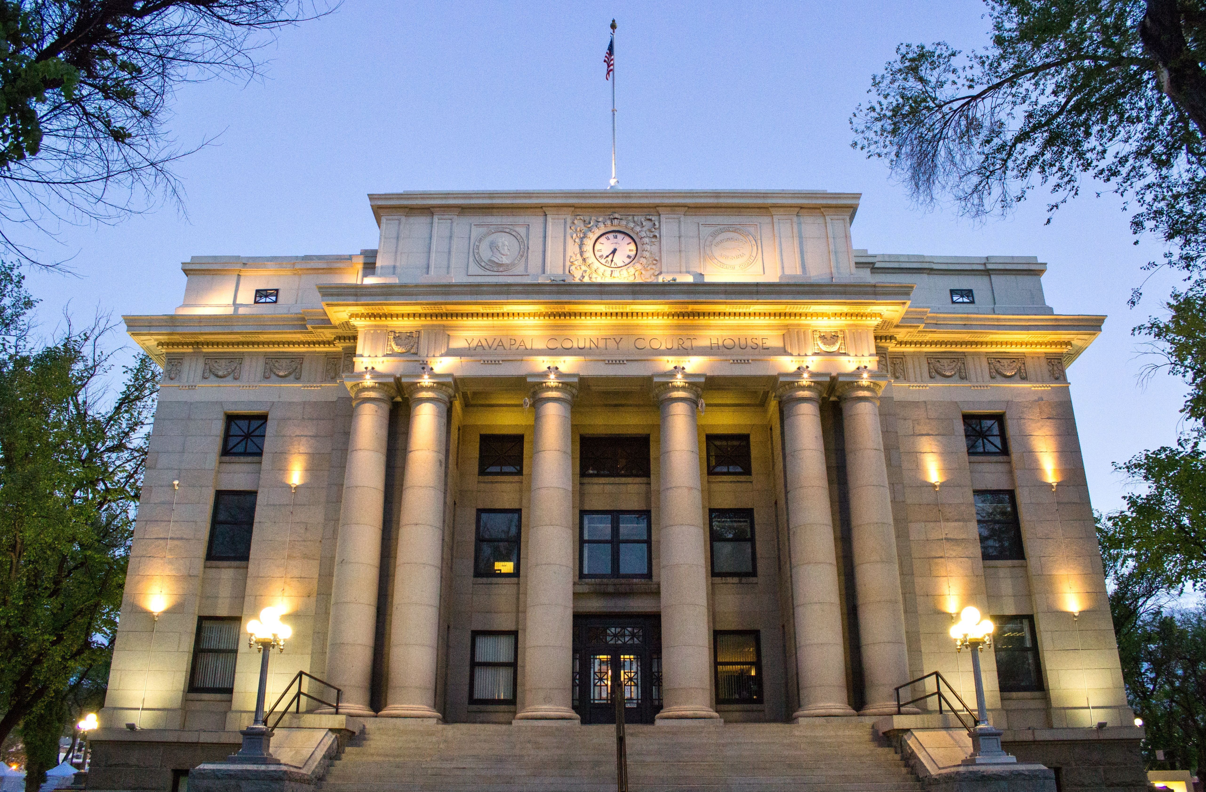 Yavapai County Courthouse front facade lit at dusk in downtown Prescott, Arizona